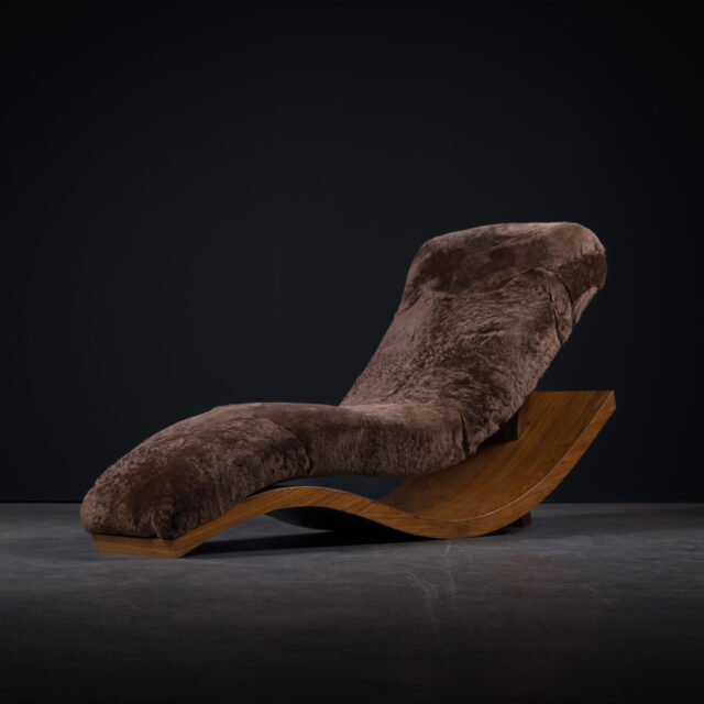 A luxurious lounge chair with a sheepskin seat cover on a wavy wooden base, blending comfort with unique design.