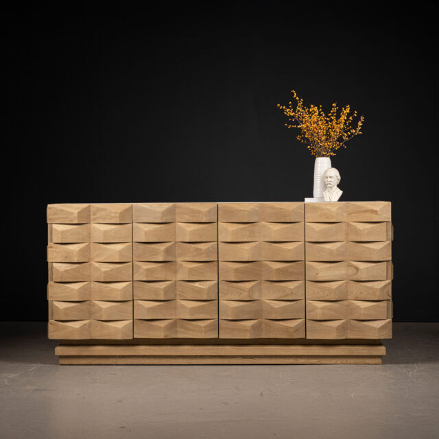 Sculpted wood credenza with intricate wave-like patterns on the front panels, showcasing a contemporary and artistic design in natural oak.