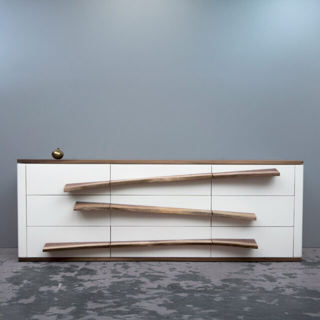 Modern Niagra dresser featuring a minimalist white base with natural live-edge wood drawer pulls, blending contemporary design with organic elements.