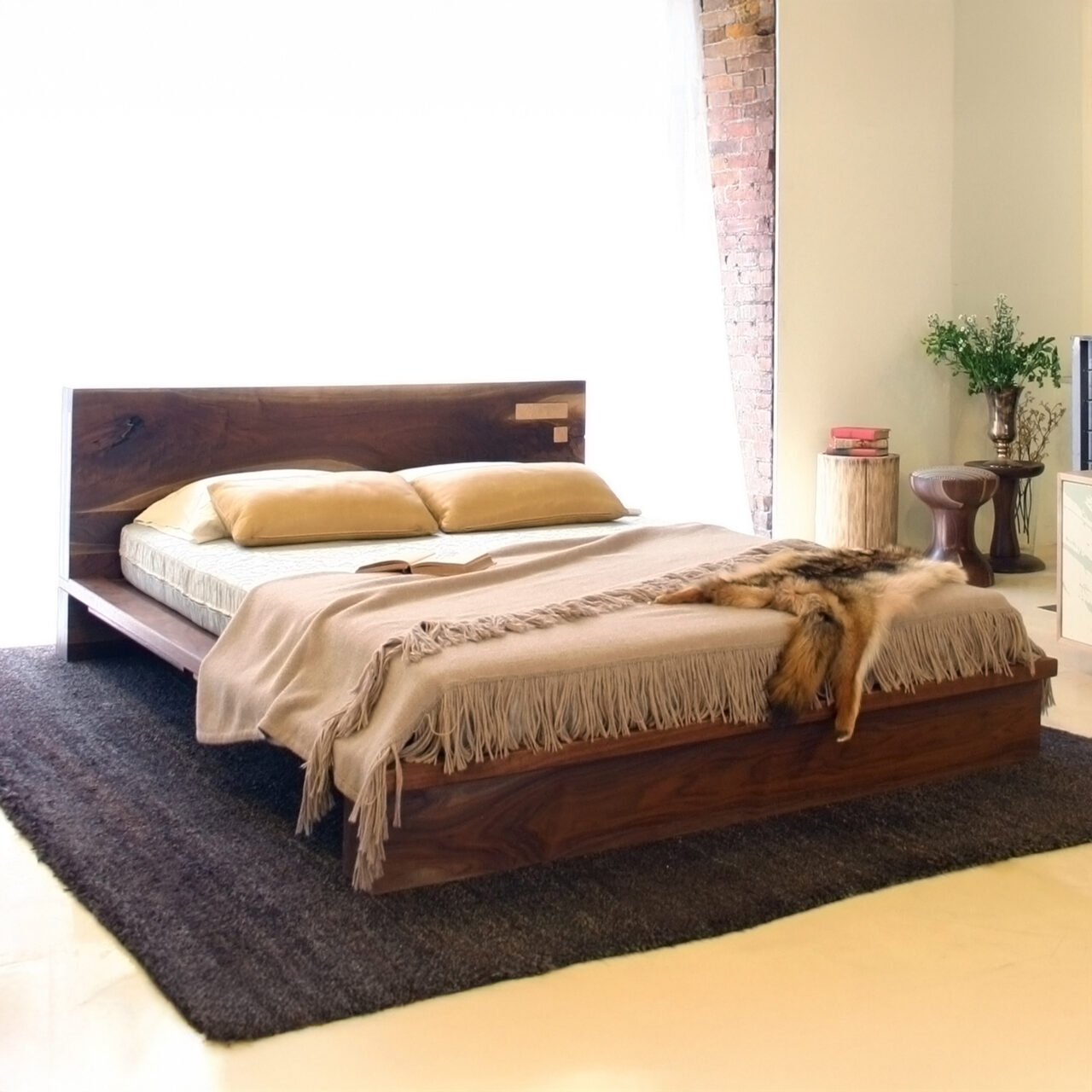 Solid wood Liffey bed with a handcrafted live-edge walnut headboard, set against a bright modern interior.