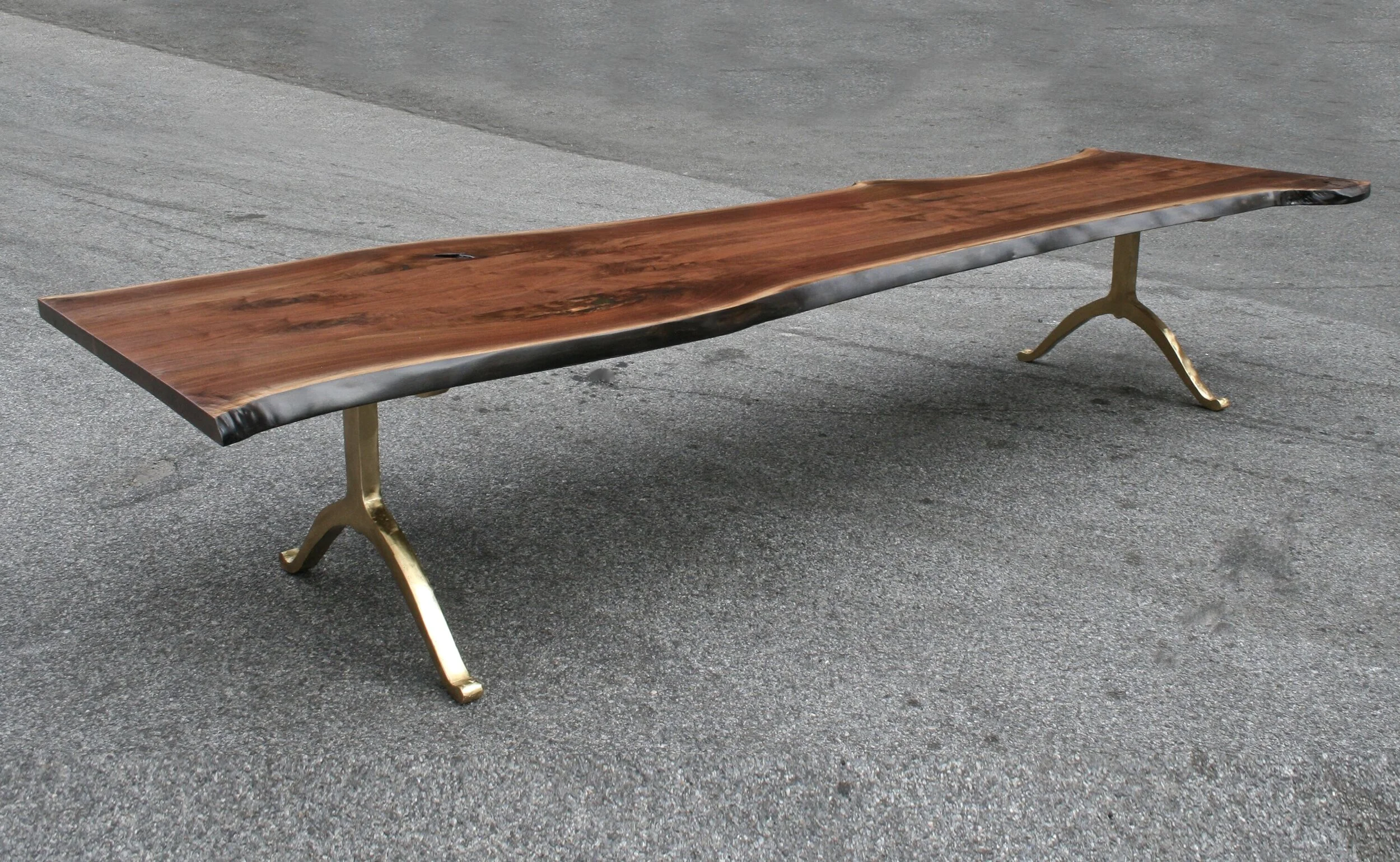 A SENTIENT Live Edge Table With Polished Brass Wishbone Bases