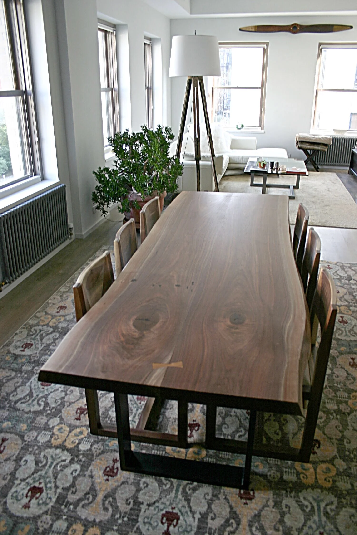 A SENTIENT Signature Live Edge Table In American Black Walnut With A Blackened Steel Frame Base