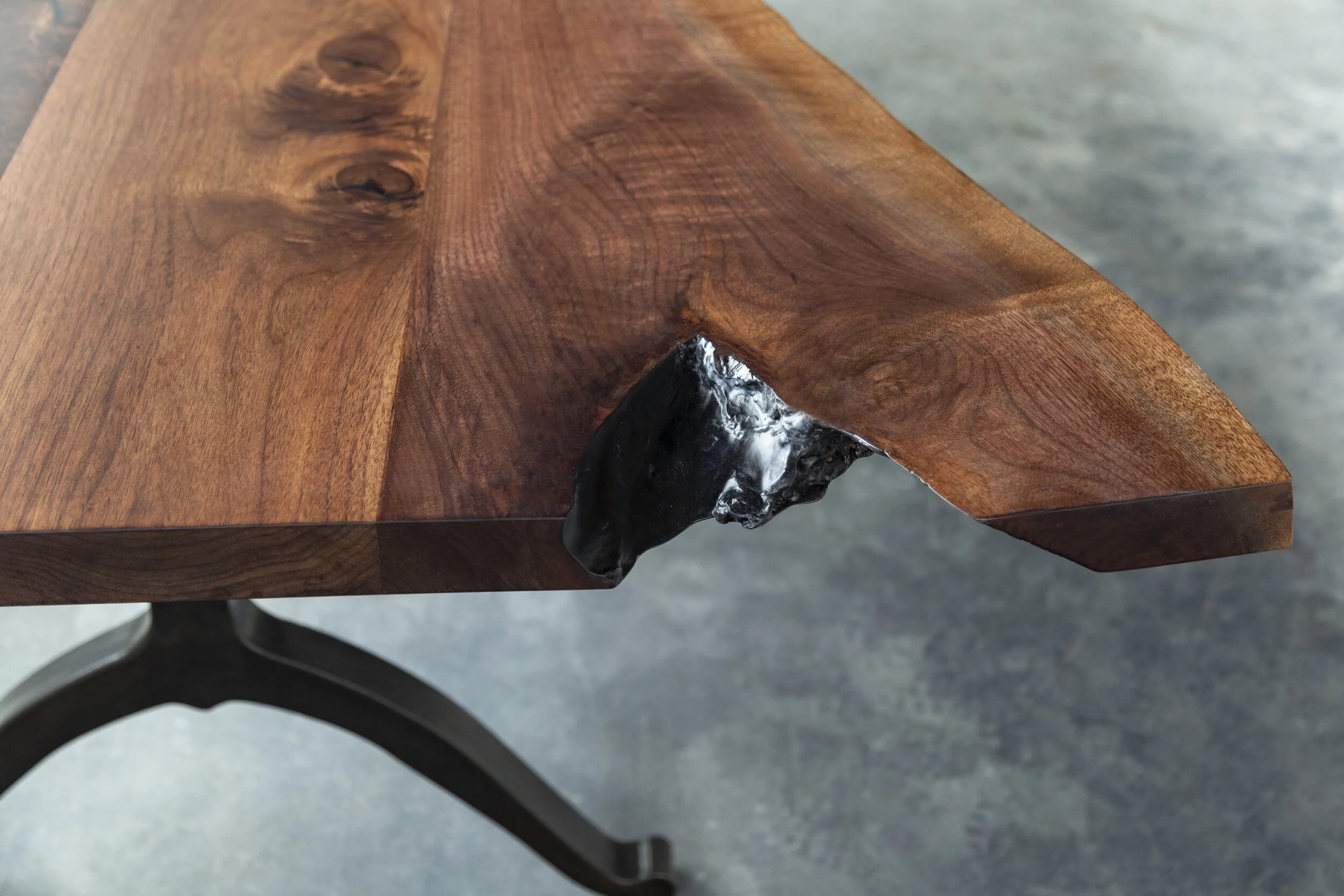 A Live Edge Dinning Table In American Black Walnut And Blackened Steel Wishbone Legs